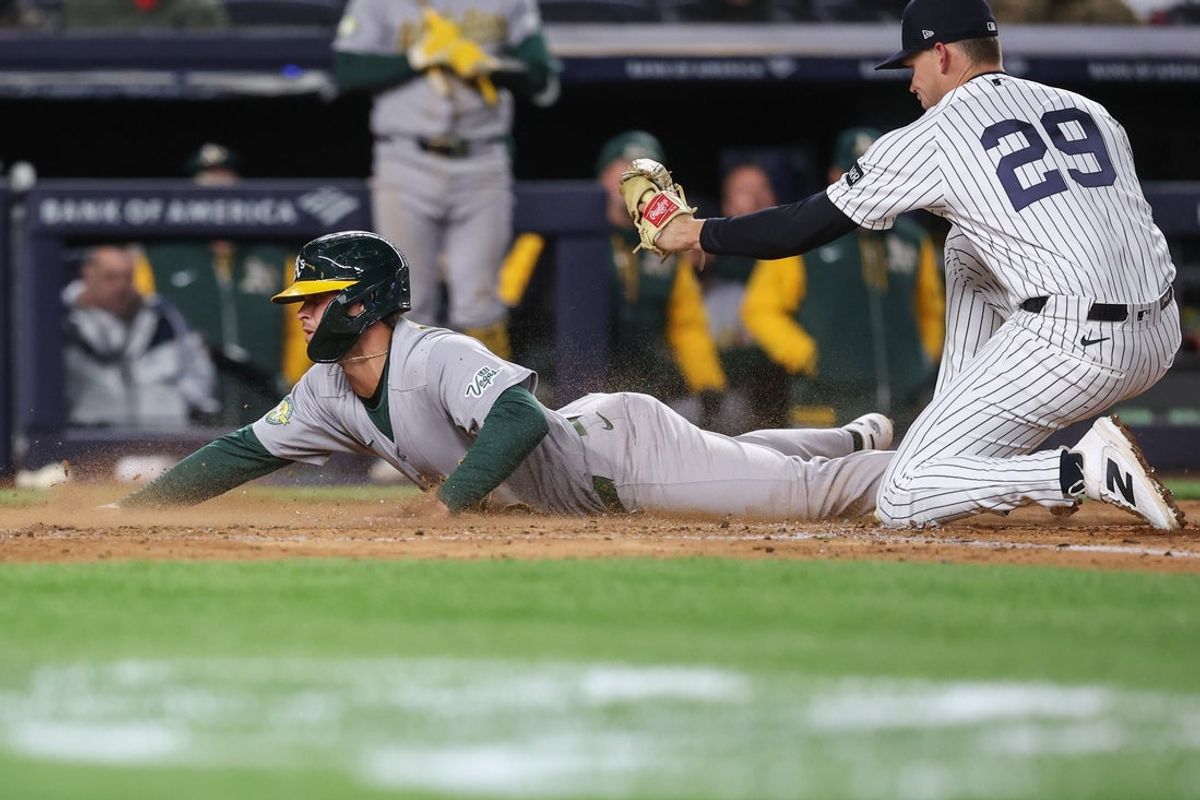 Apr 8, 2026; Bronx, New York, USA; Athletics third baseman Max Muncy (3) slides safely past the tag of New York Yankees starting pitcher Will Warren (29) in the fourth inning at Yankee Stadium. Mandatory Credit: Wendell Cruz-Imagn Images