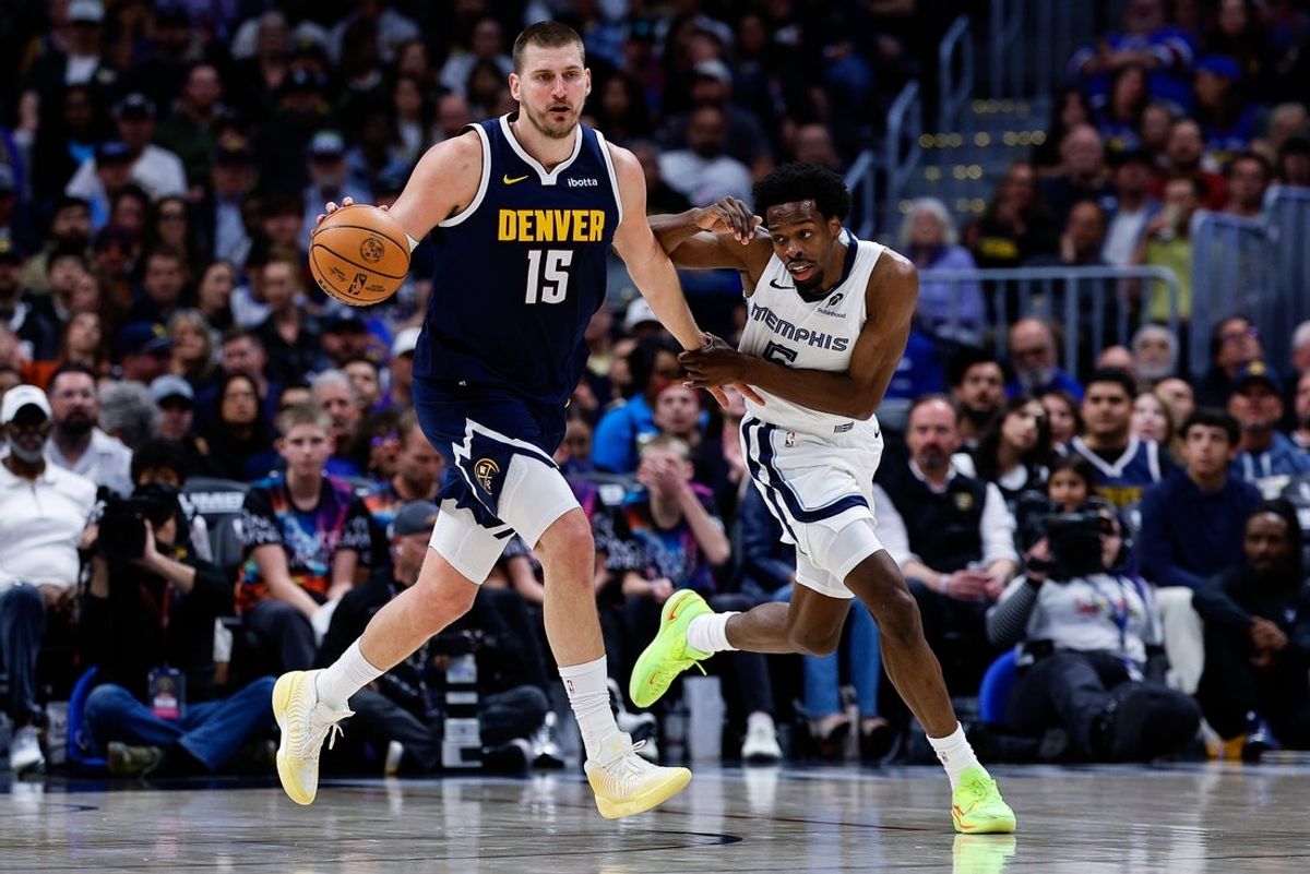 Apr 8, 2026; Denver, Colorado, USA; Denver Nuggets center Nikola Jokic (15) dribbles the ball up court as Memphis Grizzlies forward Toby Okani (5) guards in the second quarter at Ball Arena. Mandatory Credit: Isaiah J. Downing-Imagn Images