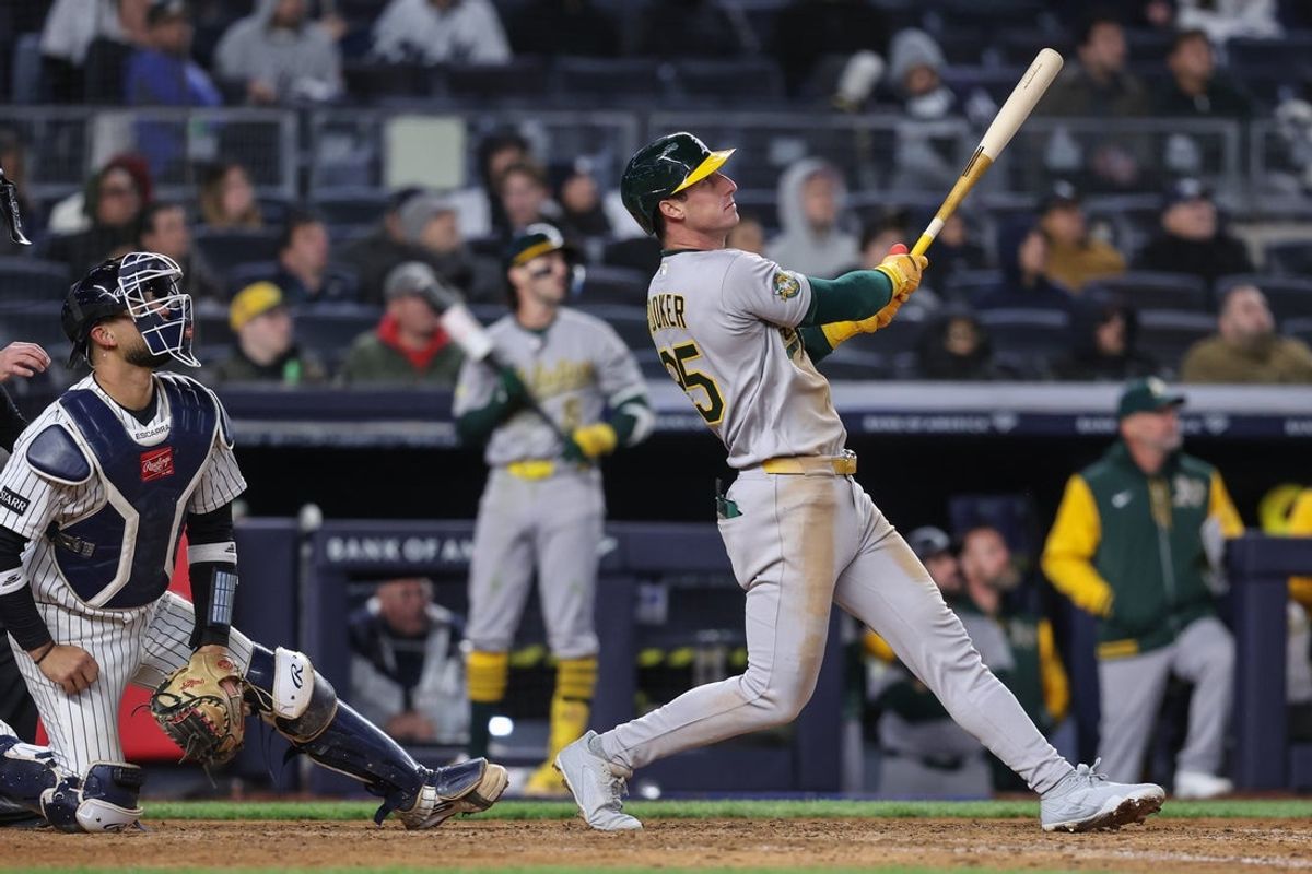 Apr 8, 2026; Bronx, New York, USA; Athletics designated hitter Brent Rooker (25) hits a run scoring sacrifice fly in the ninth inning against the New York Yankees at Yankee Stadium. Mandatory Credit: Wendell Cruz-Imagn Images
