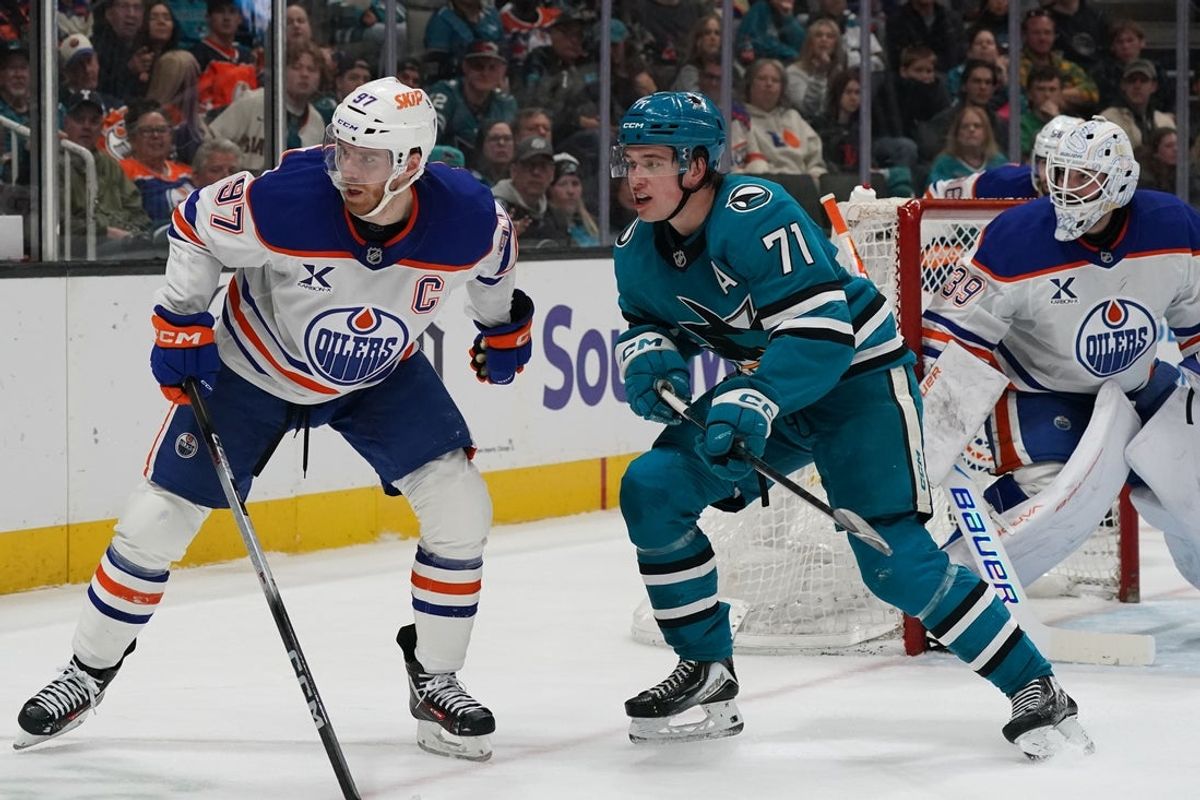 Apr 8, 2026; San Jose, California, USA;  San Jose Sharks center Macklin Celebrini (71) and Edmonton Oilers center Connor McDavid (97) wait for the puck along with Edmonton Oilers goalie Connor Ingram (39) in the second period at SAP Center at San Jose. Mandatory Credit: David Gonzales-Imagn Images