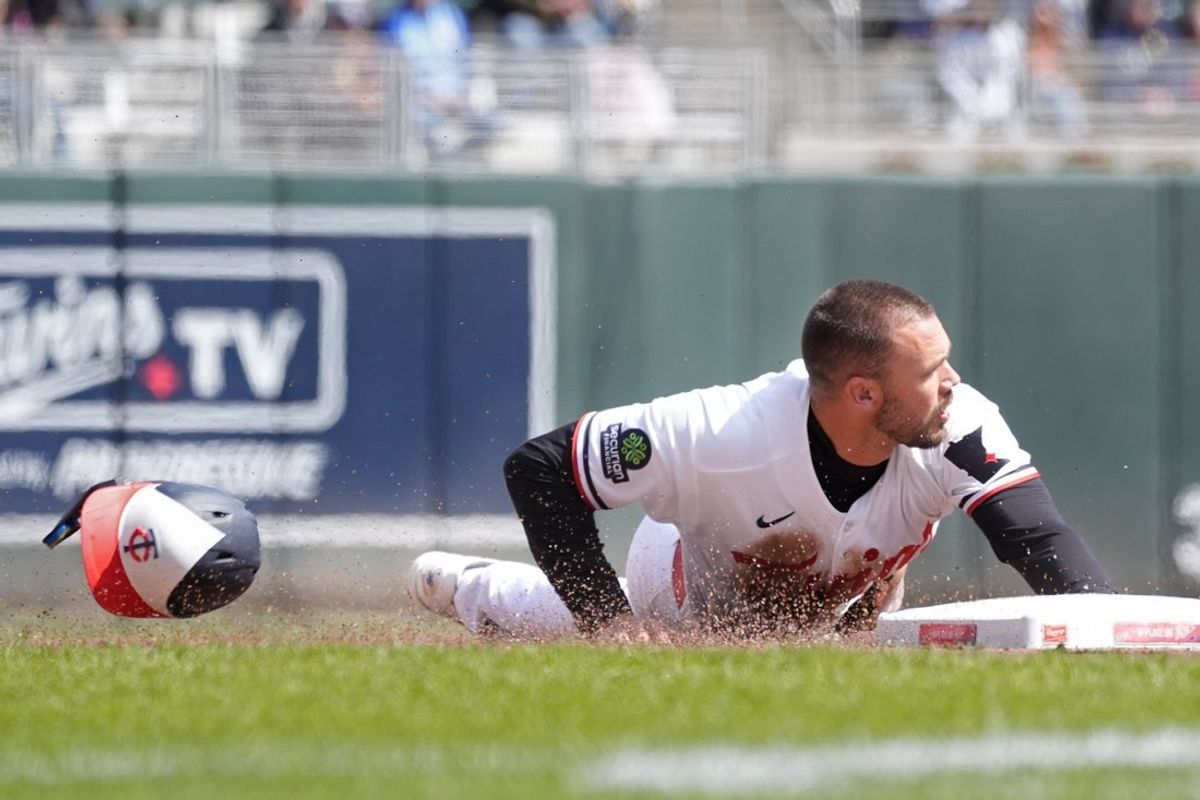 Apr 9, 2026; Minneapolis, Minnesota, USA; Minnesota Twins designated hitter Trevor Larnach (9) slides into third base on a single by Minnesota Twins first baseman Josh Bell (not pictured) against the Detroit Tigers in the first inning at Target Field. Mandatory Credit: Bruce Kluckhohn-Imagn Images