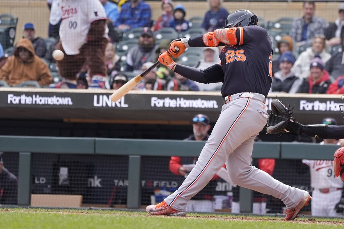 Apr 9, 2026; Minneapolis, Minnesota, USA; Detroit Tigers designated hitter Gleyber Torres (25) hits a sacrifice fly against the Minnesota Twins in the seventh inning at Target Field. Mandatory Credit: Bruce Kluckhohn-Imagn Images