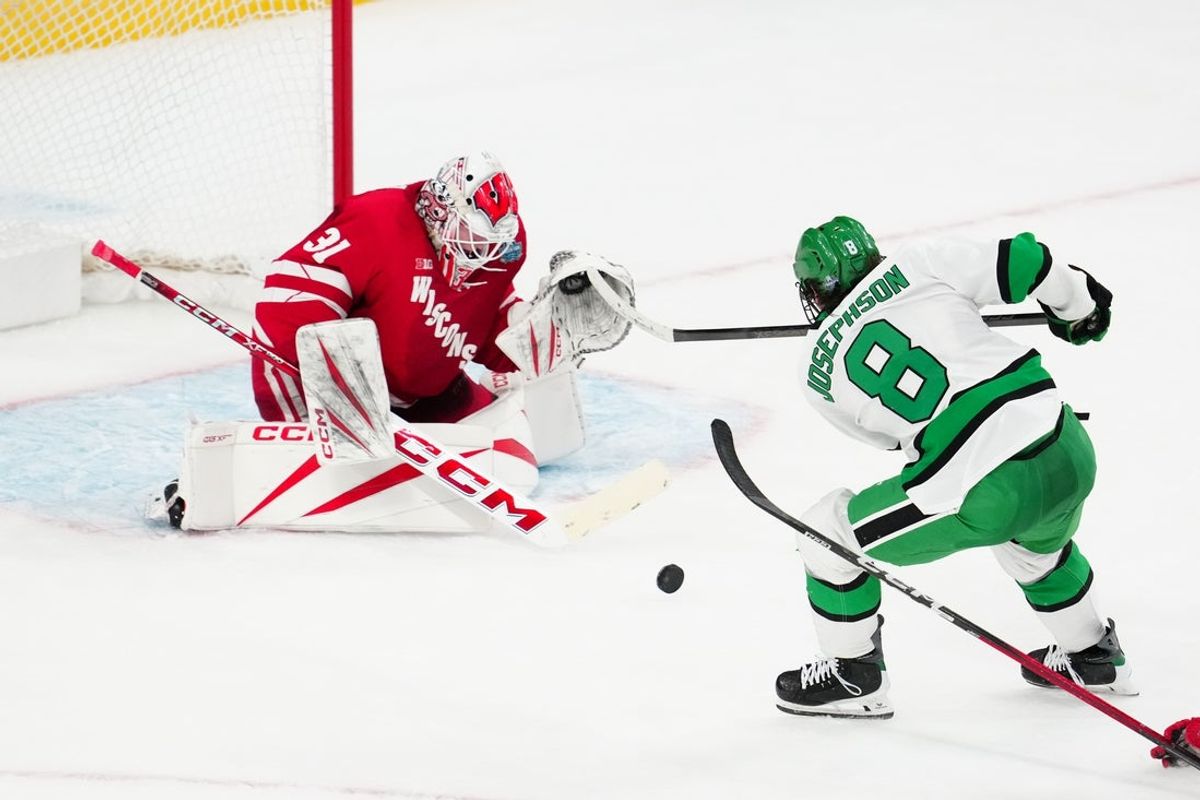 Apr 9, 2026; Las Vegas, Nevada, UNITED STATES; Wisconsin Badgers goalie Daniel Hauser (31) blocks a shot on goal by North Dakota Fighting Hawks forward Ollie Josephson (8) in the second period in the semifinals of the NCAA men's ice hockey Frozen Four at T-Mobile Arena. Mandatory Credit: Stephen R. Sylvanie-Imagn Images