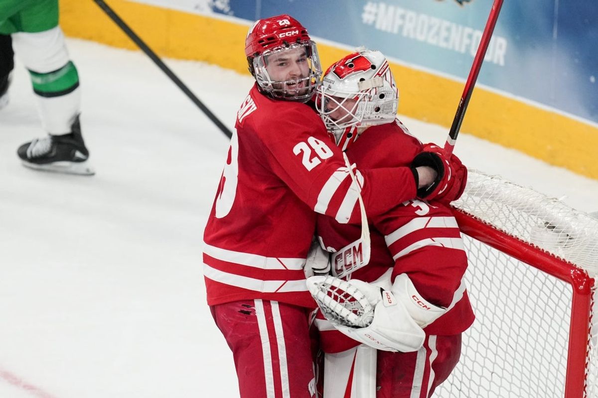 Apr 9, 2026; Las Vegas, Nevada, UNITED STATES; Wisconsin Badgers defenseman Aiden Dubinsky (28) celebrates with goalie Daniel Hauser (31) after defeating North Dakota Fighting Hawks in the semifinals of the NCAA men's ice hockey Frozen Four at T-Mobile Arena. Mandatory Credit: Lucas Peltier-Imagn Images