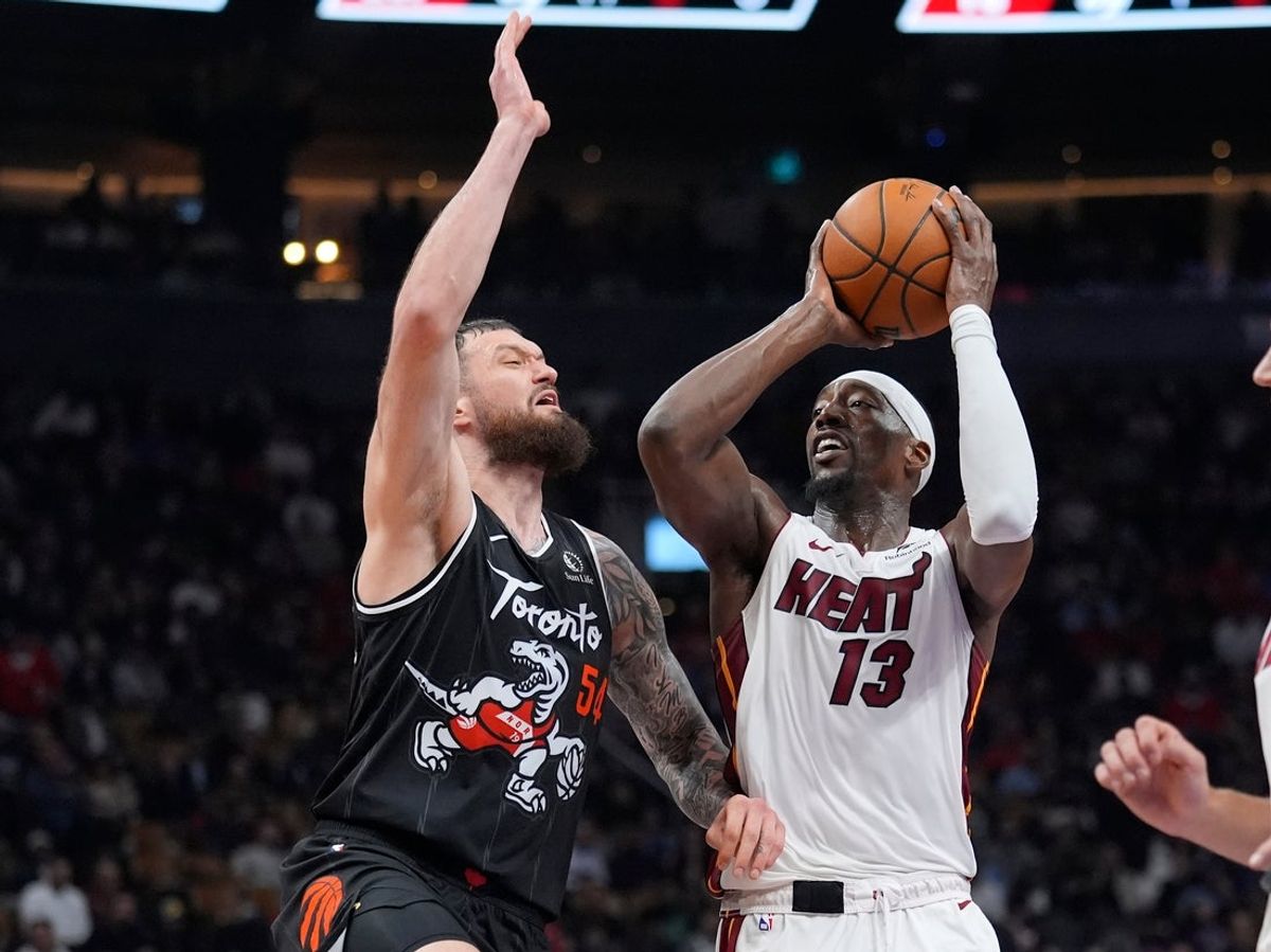 Apr 9, 2026; Toronto, Ontario, CAN; Miami Heat forward Bam Adebayo (13) shoots the ball against Toronto Raptors forward Sandro Mamukelashvili (54) during the first half at Scotiabank Arena. Mandatory Credit: John E. Sokolowski-Imagn Images