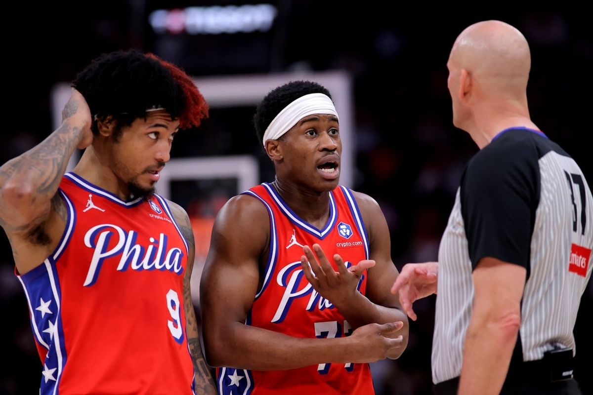 Apr 9, 2026; Houston, Texas, USA; Philadelphia 76ers guard VJ Edgecombe (77) and forward Kelly Oubre Jr. (9) talk with NBA referee Eric Dalen (37) during the second quarter against the Houston Rockets at Toyota Center. Mandatory Credit: Erik Williams-Imagn Images