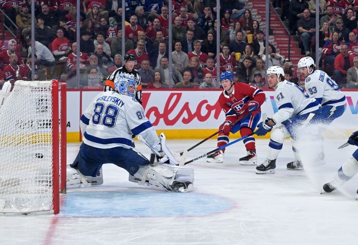 Apr 9, 2026; Montreal, Quebec, CAN; Montreal Canadiens forward Cole Caufield (13) scores his fiftieth goal of the season against Tampa Bay Lightning goalie Andrei Vasilevskiy (88) during the second period at the Bell Centre. Mandatory Credit: Eric Bolte-Imagn Images