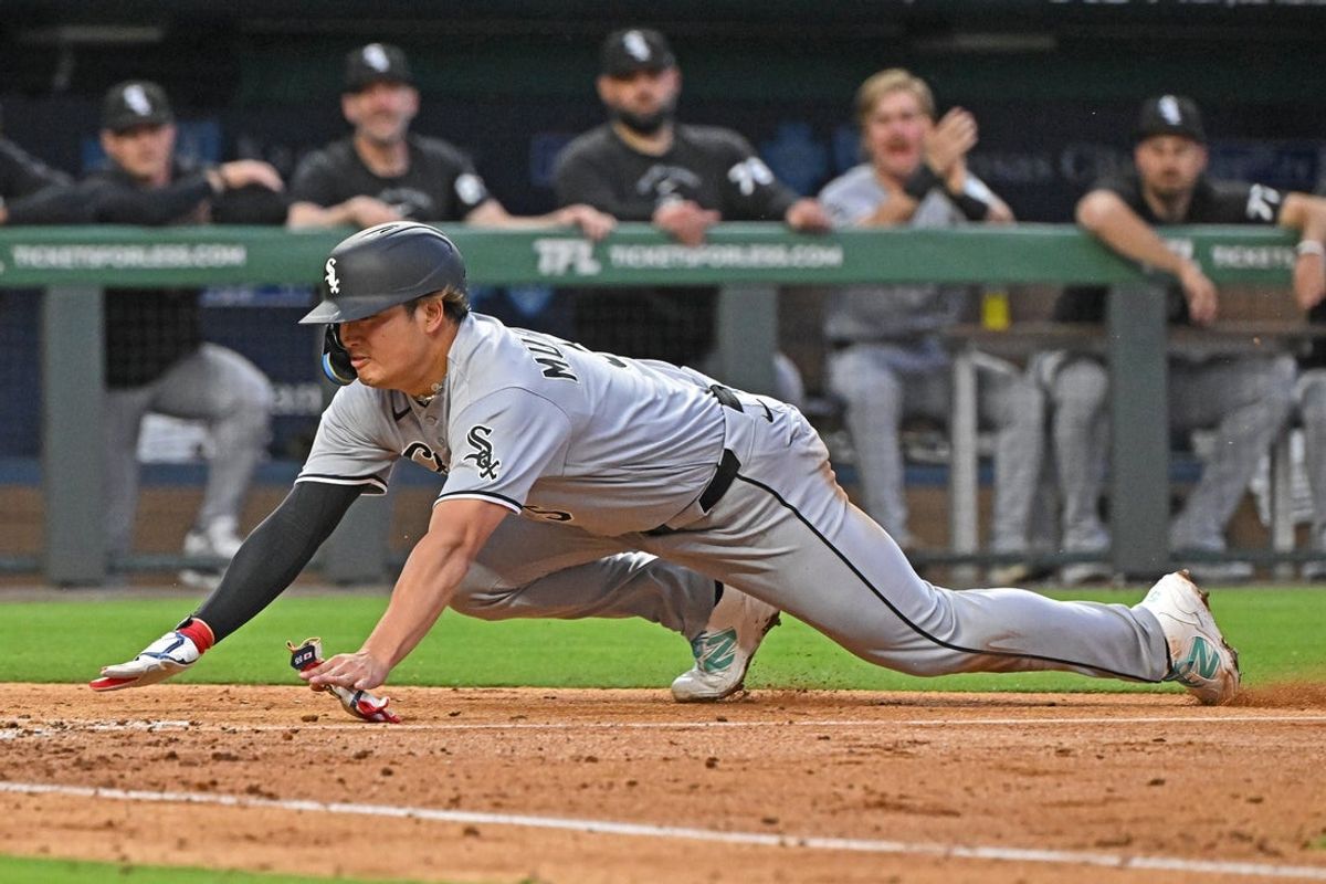 Apr 9, 2026; Kansas City, Missouri, USA;  Chicago White Sox first baseman Munetaka Murakami (5) slides headfirst to score a run in the fourth inning against the Kansas City Royals at Kauffman Stadium. Mandatory Credit: Peter Aiken-Imagn Images