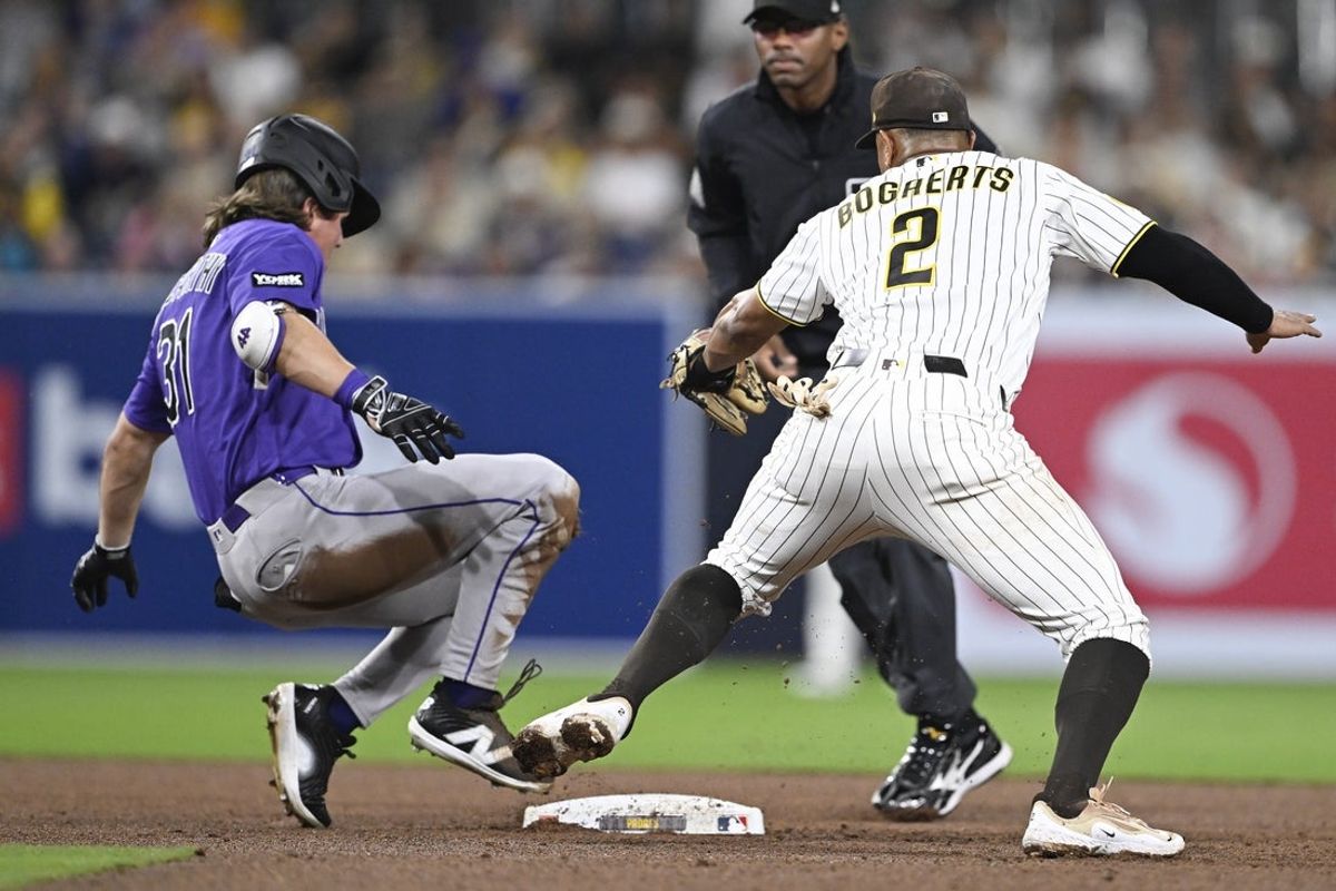 Apr 9, 2026; San Diego, California, USA; Colorado Rockies center fielder Jake McCarthy (31) is tagged out at second base by San Diego Padres shortstop Xander Bogaerts (2) as he tries to strech a single during the fifth inning at Petco Park. Mandatory Credit: Denis Poroy-Imagn Images