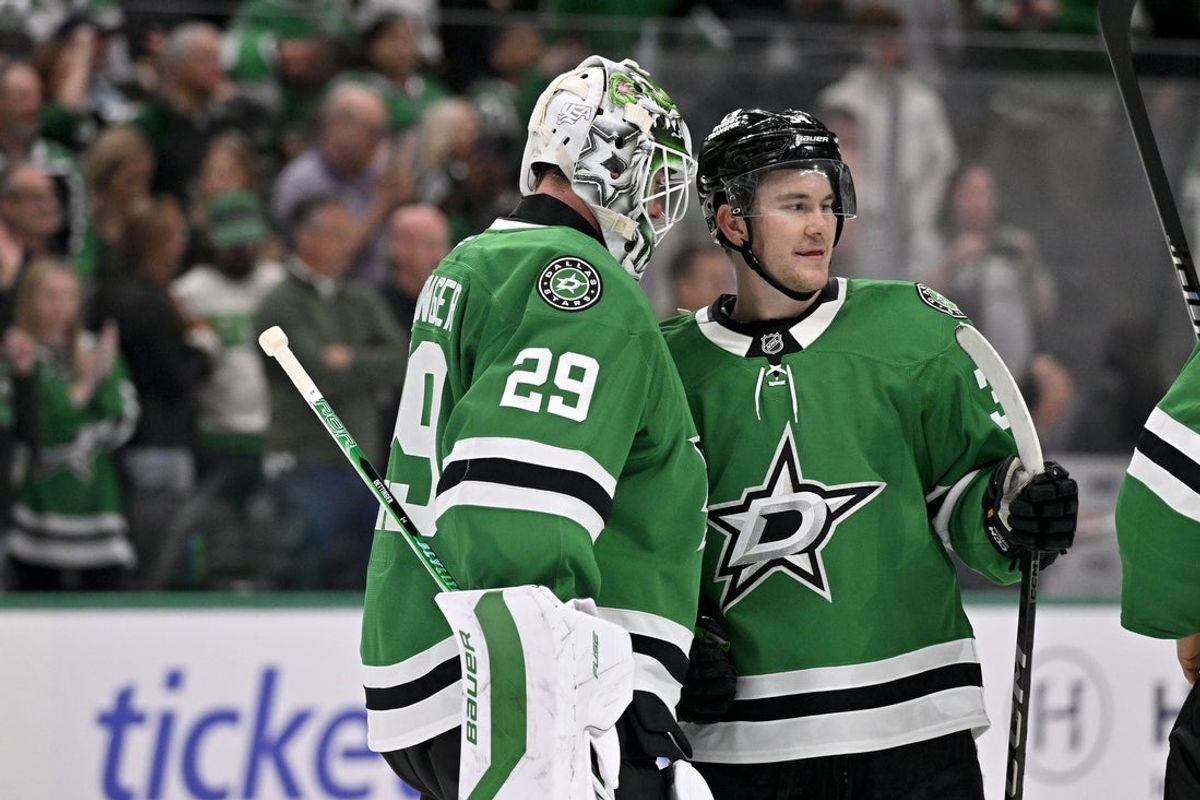 Apr 9, 2026; Dallas, Texas, USA; Dallas Stars goaltender Jake Oettinger (29) and center Cameron Hughes (34) celebrate the Stars victory over the Minnesota Wild at the American Airlines Center. Mandatory Credit: Jerome Miron-Imagn Images