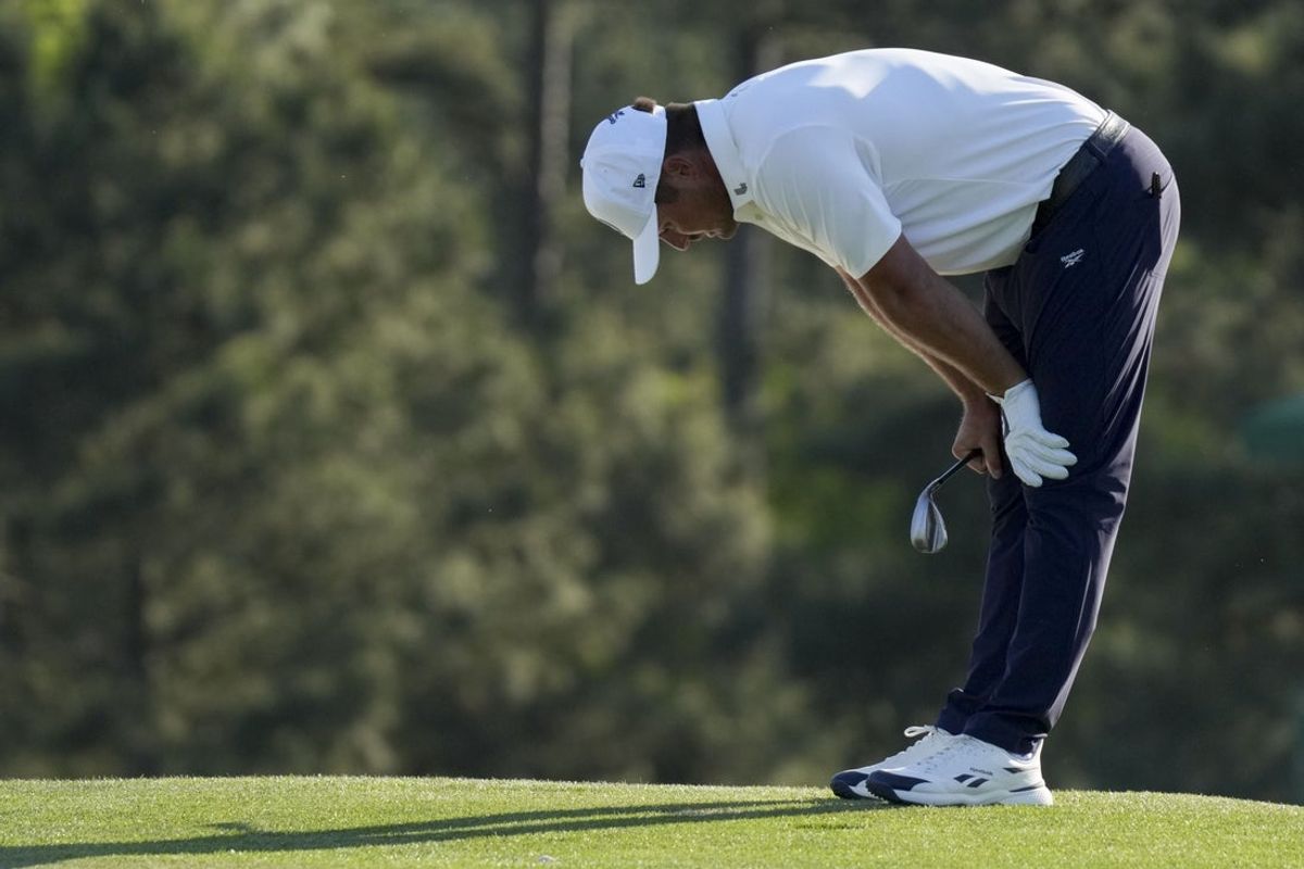 Apr 10, 2026; Augusta, Georgia, USA; Bryson DeChambeau reacts after his ball rolled down the slope on the 18th green during the second round of the Masters Tournament at Augusta National Golf Club. Mandatory Credit: Grace Smith-Imagn Images