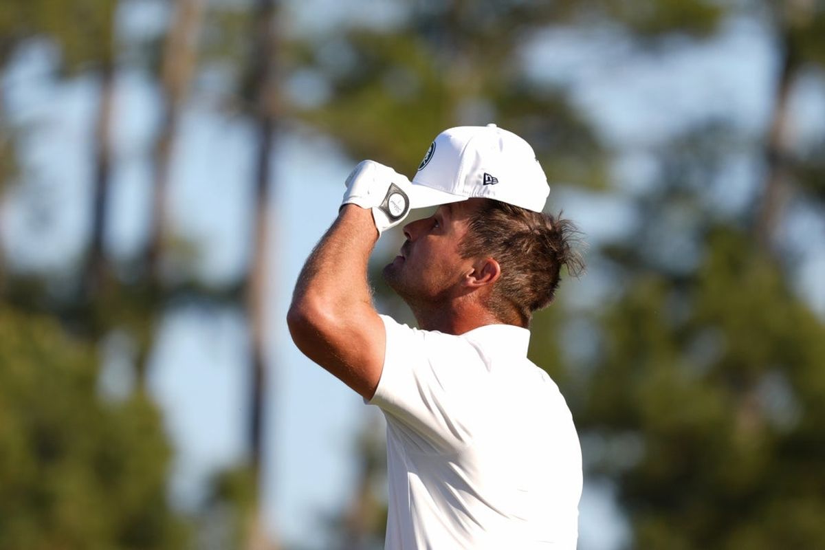 Apr 10, 2026; Augusta, Georgia, USA; Bryson DeChambeau reacts after a shot from a bunker on the 18th hole during the second round of the Masters Tournament at Augusta National Golf Club. Mandatory Credit: Katie Goodale-Imagn Images