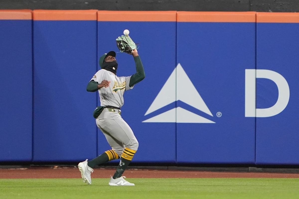 Apr 10, 2026; New York City, New York, USA; Athletics center fielder Denzel Clarke (1) catches a fly ball against the New York Mets during the second inning at Citi Field. Mandatory Credit: Gregory Fisher-Imagn Images