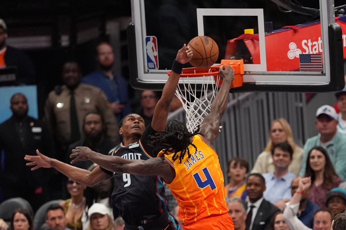 Apr 10, 2026; Charlotte, North Carolina, USA;  Charlotte Hornets guard Sion James (4) is fouled by Detroit Pistons guard/forward Ausar Thompson (9) at the rim during the second quarter at Spectrum Center. Mandatory Credit: Jim Dedmon-Imagn Images