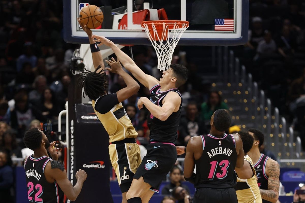 Apr 10, 2026; Washington, District of Columbia, USA; Washington Wizards guard Bilal Coulibaly (0) shoots the ball as Miami Heat forward Simone Fontecchio (0) defends in the first half at Capital One Arena. Mandatory Credit: Geoff Burke-Imagn Images