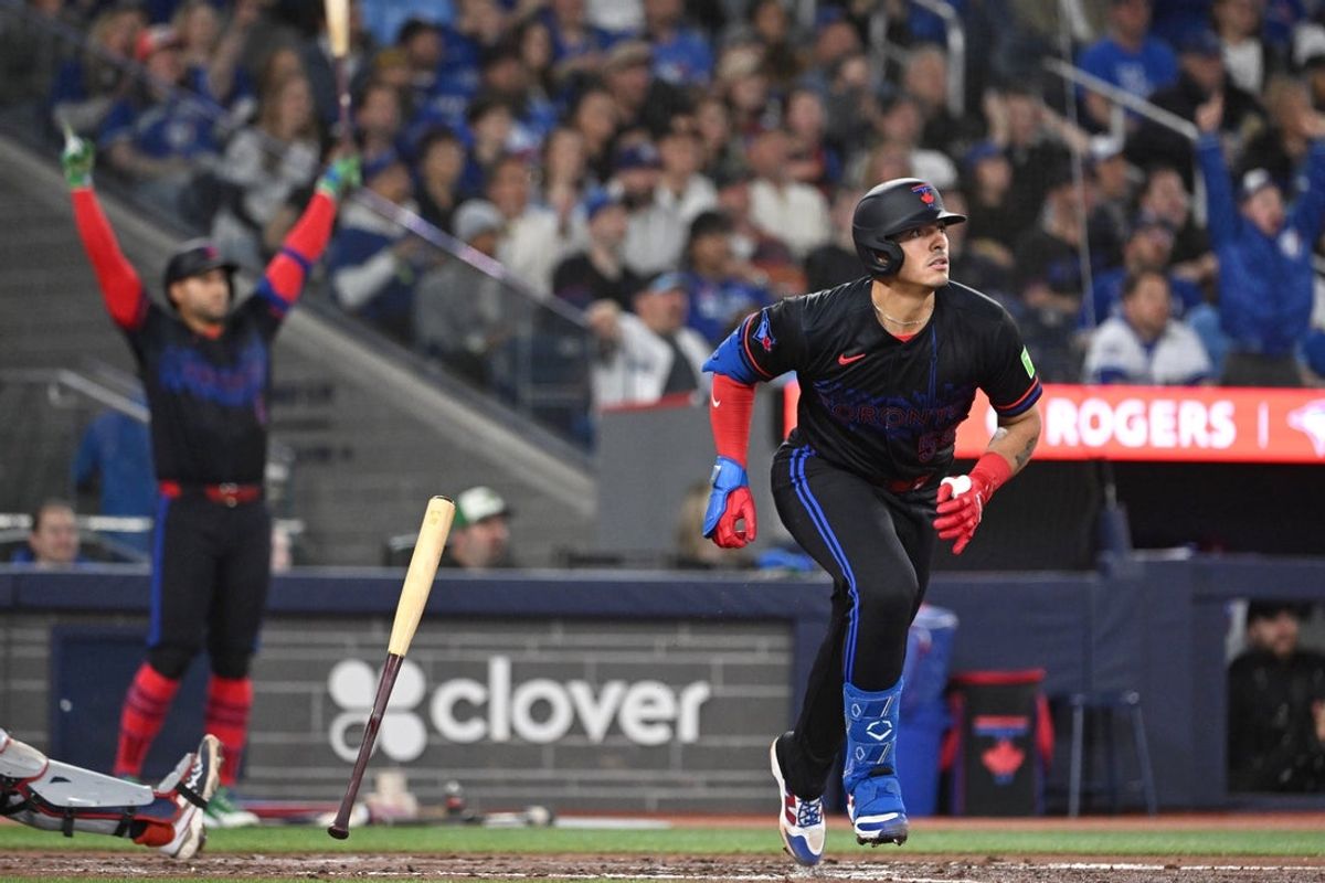 Apr 10, 2026; Toronto, Ontario, CAN;  Toronto Blue Jays catcher Brandon Valenzuela (59) hits a two-run home run as designated hitter George Springer (4) reacts against the Minnesota Twins in the fourth inning at Rogers Centre. Mandatory Credit: Dan Hamilton-Imagn Images
