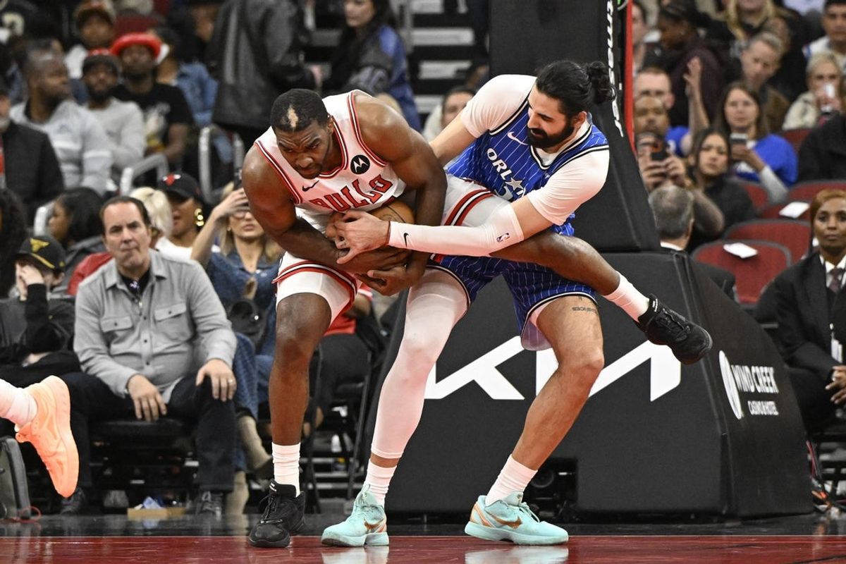 Apr 10, 2026; Chicago, Illinois, USA;  Chicago Bulls forward Patrick Williams (44) and Orlando Magic center/forward Goga Bitadze (35) grab a loose ball during the first half at the United Center. Mandatory Credit: Matt Marton-Imagn Images