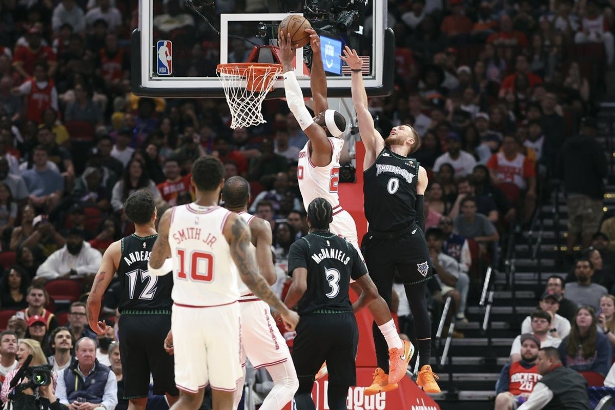 Apr 10, 2026; Houston, Texas, USA; Houston Rockets guard Josh Okogie (20) attempts to score a basket as Minnesota Timberwolves guard Donte DiVincenzo (0) defends during the first quarter at Toyota Center. Mandatory Credit: Troy Taormina-Imagn Images