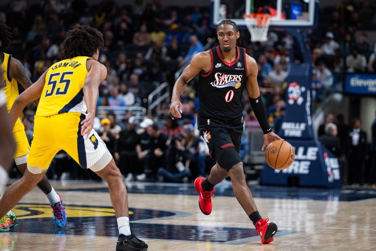 Apr 10, 2026; Indianapolis, Indiana, USA; Philadelphia 76ers guard Tyrese Maxey (0) dribbles the ball while Indiana Pacers guard Ethan Thompson (55) defends in the second half at Gainbridge Fieldhouse. Mandatory Credit: Trevor Ruszkowski-Imagn Images