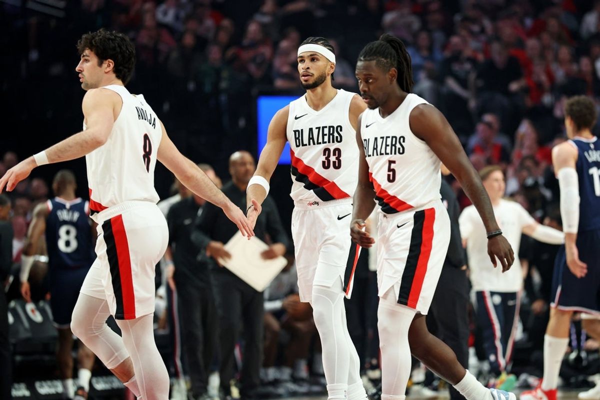 Apr 10, 2026; Portland, Oregon, USA;  Portland Trail Blazers forward Deni Avdija (8) high-fives forward Toumani Camara (33) as guard Jrue Holiday (5) heads to the bench during a timeout in the first half against the LA Clippers at Moda Center. Mandatory Credit: Jaime Valdez-Imagn Images