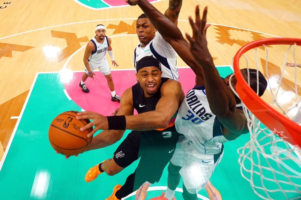 Apr 10, 2026; San Antonio, Texas, USA; San Antonio Spurs forward Keldon Johnson (3) drives to the basket against Dallas Mavericks center Moussa Cisse (30) during the first half at Frost Bank Center. Mandatory Credit: Scott Wachter-Imagn Images