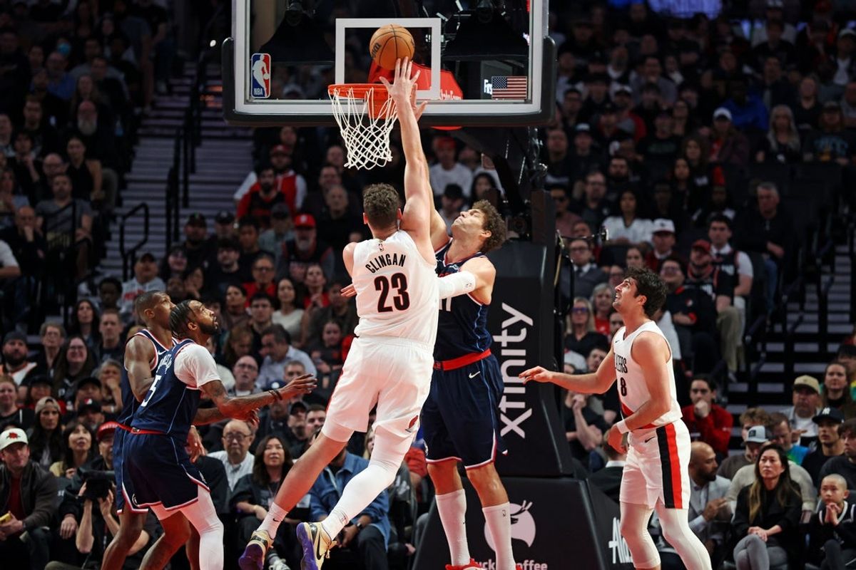 Apr 10, 2026; Portland, Oregon, USA;  Portland Trail Blazers center Donovan Clingan (23) scores over LA Clippers center Brook Lopez (11) during the first half at Moda Center. Mandatory Credit: Jaime Valdez-Imagn Images
