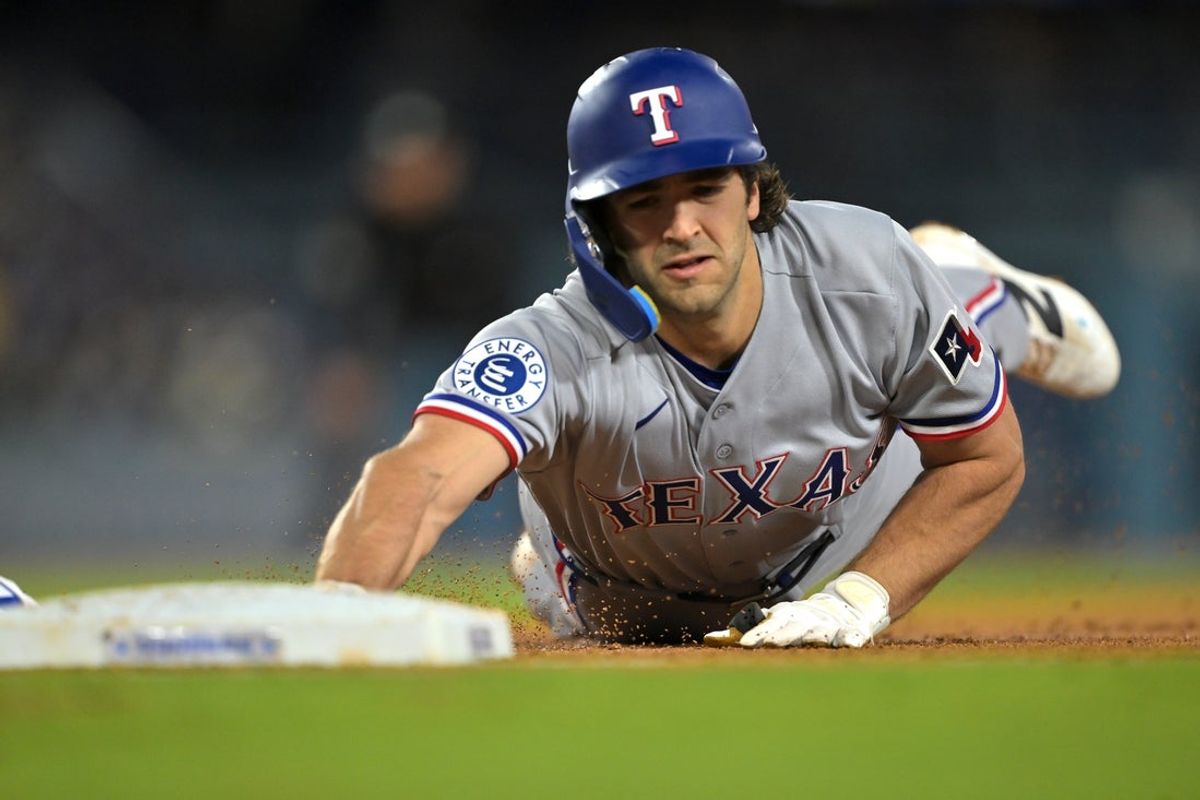 Apr 10, 2026; Los Angeles, California, USA;  Texas Rangers shortstop Josh Smith (8) dives back to first base on a pick off attempt by the Los Angeles Dodgers during the third inning at Dodger Stadium. Mandatory Credit: Jayne Kamin-Oncea-Imagn Images
