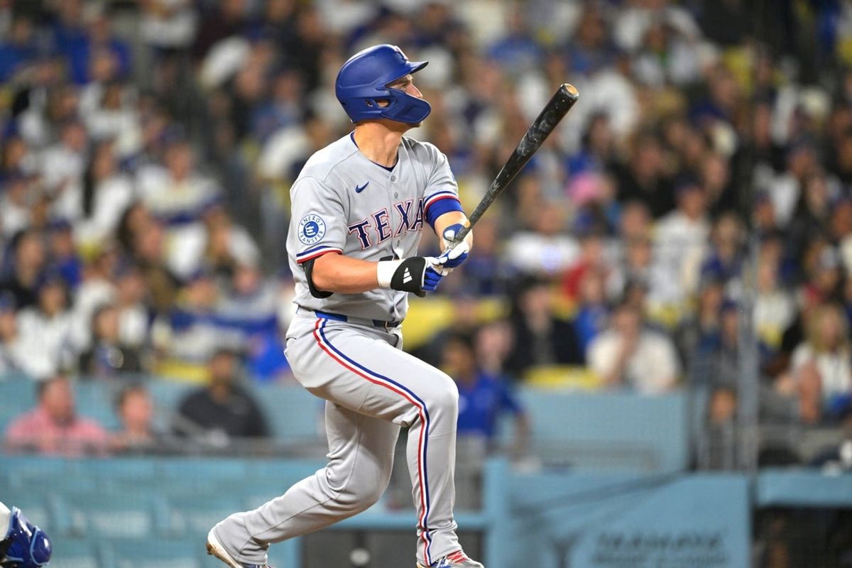 Apr 10, 2026; Los Angeles, California, USA;  Texas Rangers shortstop Corey Seager (5) hits a three-run home run home run against the Los Angeles Dodgers during the third inning at Dodger Stadium. Mandatory Credit: Jayne Kamin-Oncea-Imagn Images