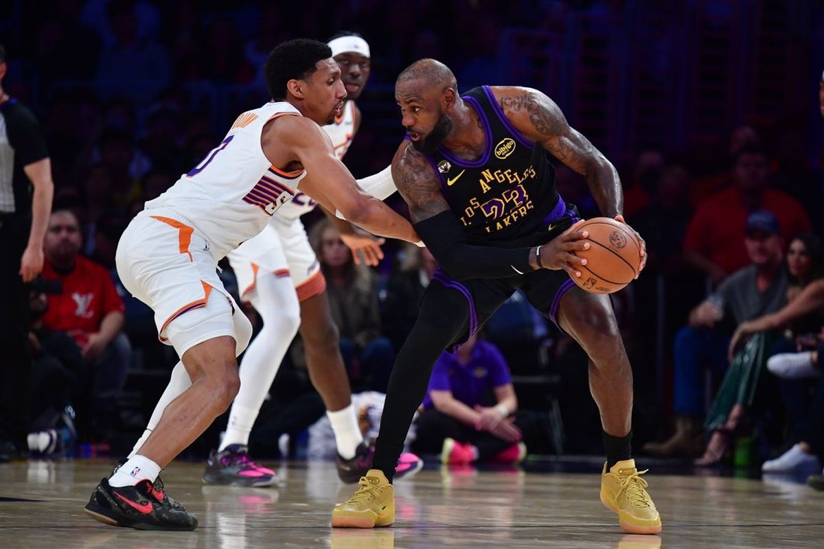 Apr 10, 2026; Los Angeles, California, USA; Los Angeles Lakers forward LeBron James (23) controls the ball against Phoenix Suns forward Ryan Dunn (0) during the first half at Crypto.com Arena. Mandatory Credit: Gary A. Vasquez-Imagn Images