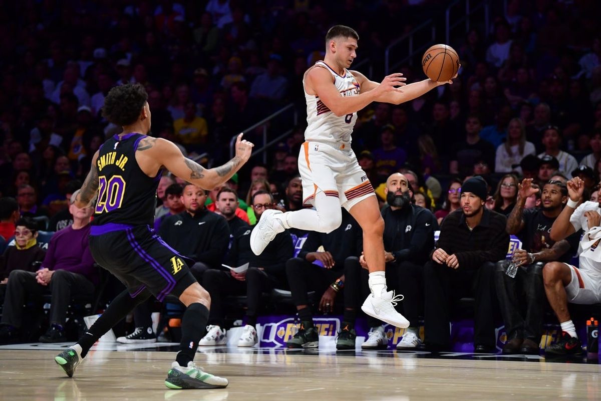 Apr 10, 2026; Los Angeles, California, USA; Phoenix Suns guard Grayson Allen (8) gets the ball against Los Angeles Lakers guard Nick Smith Jr. (20) during the first half at Crypto.com Arena. Mandatory Credit: Gary A. Vasquez-Imagn Images