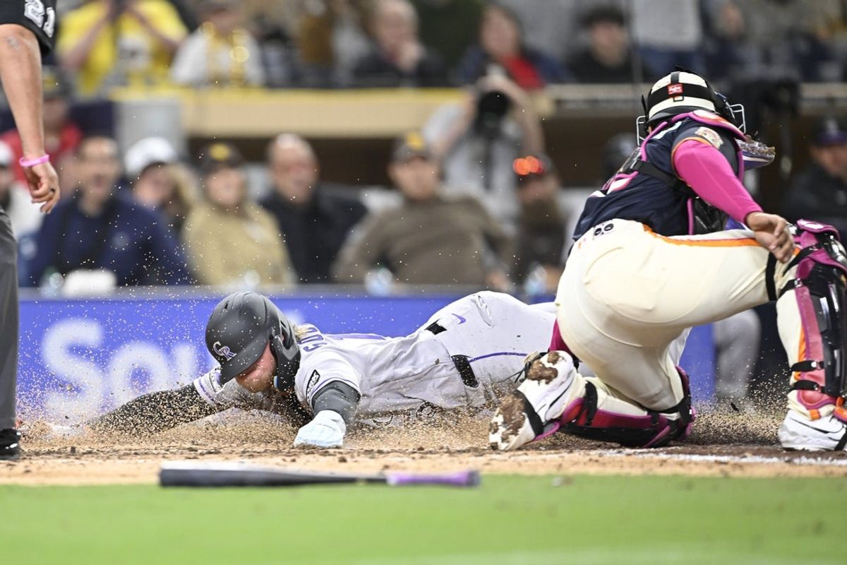 Apr 10, 2026; San Diego, California, USA; Colorado Rockies designated hitter Hunter Goodman (15) scores ahead of tag of San Diego Padres catcher Luis Campusano (12) during the eighth inning at Petco Park. Mandatory Credit: Denis Poroy-Imagn Images