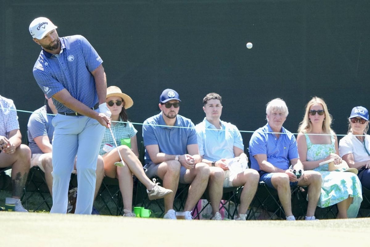 Apr 11, 2026; Augusta, Georgia, USA; Jon Rahm chips onto the 14th green during the third round of the Masters Tournament at Augusta National Golf Club. Mandatory Credit: Kyle Terada-Imagn Images