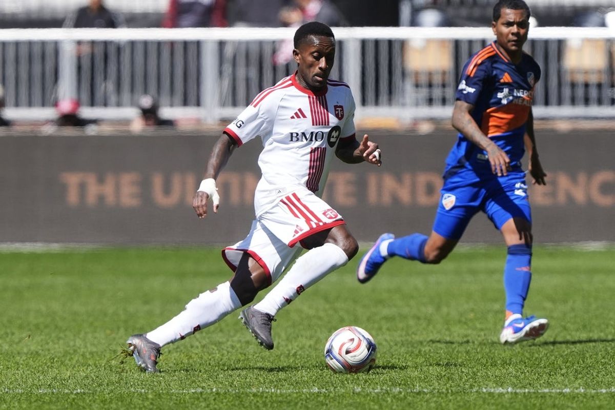 Apr 11, 2026; Toronto, Ontario, CAN; Toronto FC defender Richie Laryea (22) controls the ball against FC Cincinnati during the first half at BMO Field. Mandatory Credit: John E. Sokolowski-Imagn Images