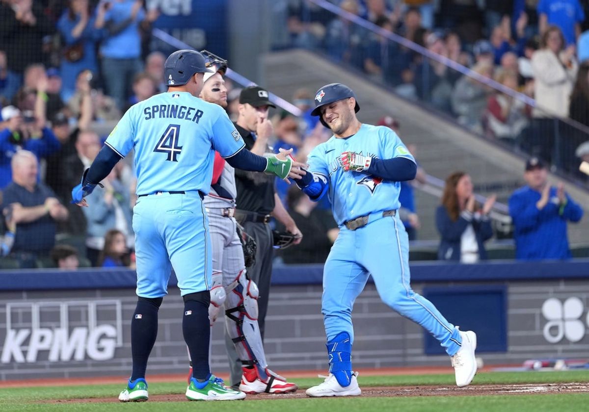 Apr 11, 2026; Toronto, Ontario, CAN; Toronto Blue Jays center fielder Daulton Varsho (5) hits a two run home run and celebrates with designated hitterr George Springer (4) against the Minnesota Twins during the first inning at Rogers Centre. Mandatory Credit: Nick Turchiaro-Imagn Images