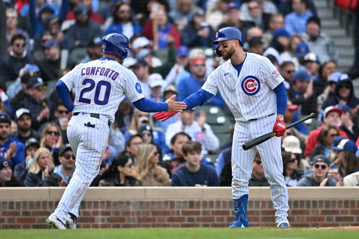 Apr 11, 2026; Chicago, Illinois, USA; Chicago Cubs right fielder Michael Conforto (20) celebrates with first baseman Michael Busch (29) after scoring against the Pittsburgh Pirates during the fifth inning at Wrigley Field. Mandatory Credit: Patrick Gorski-Imagn Images