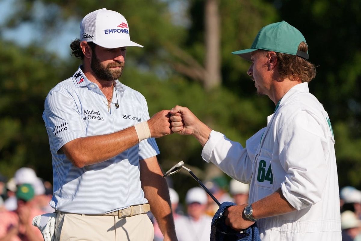 Apr 11, 2026; Augusta, Georgia, USA; Cameron Young fist bumps caddie Kyle Sterbinsky after completing the 18th hole during the third round of the Masters Tournament at Augusta National Golf Club. Mandatory Credit: Michael Madrid-Imagn Images