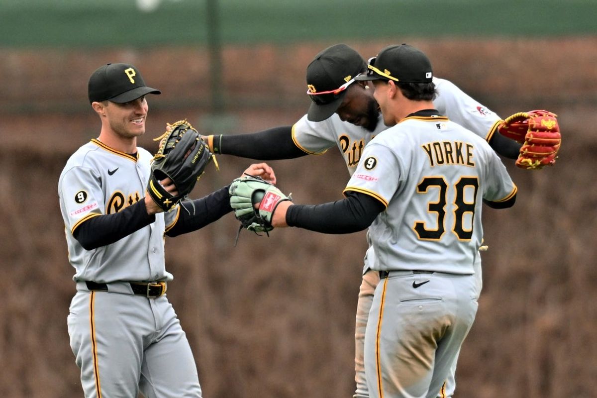 Apr 11, 2026; Chicago, Illinois, USA; Pittsburgh Pirates outfielders Jake Mangum, O’Neil Cruz, and Ryan O’Hearn (38) celebrate their victory over the Chicago Cubs at Wrigley Field. Mandatory Credit: Patrick Gorski-Imagn Images