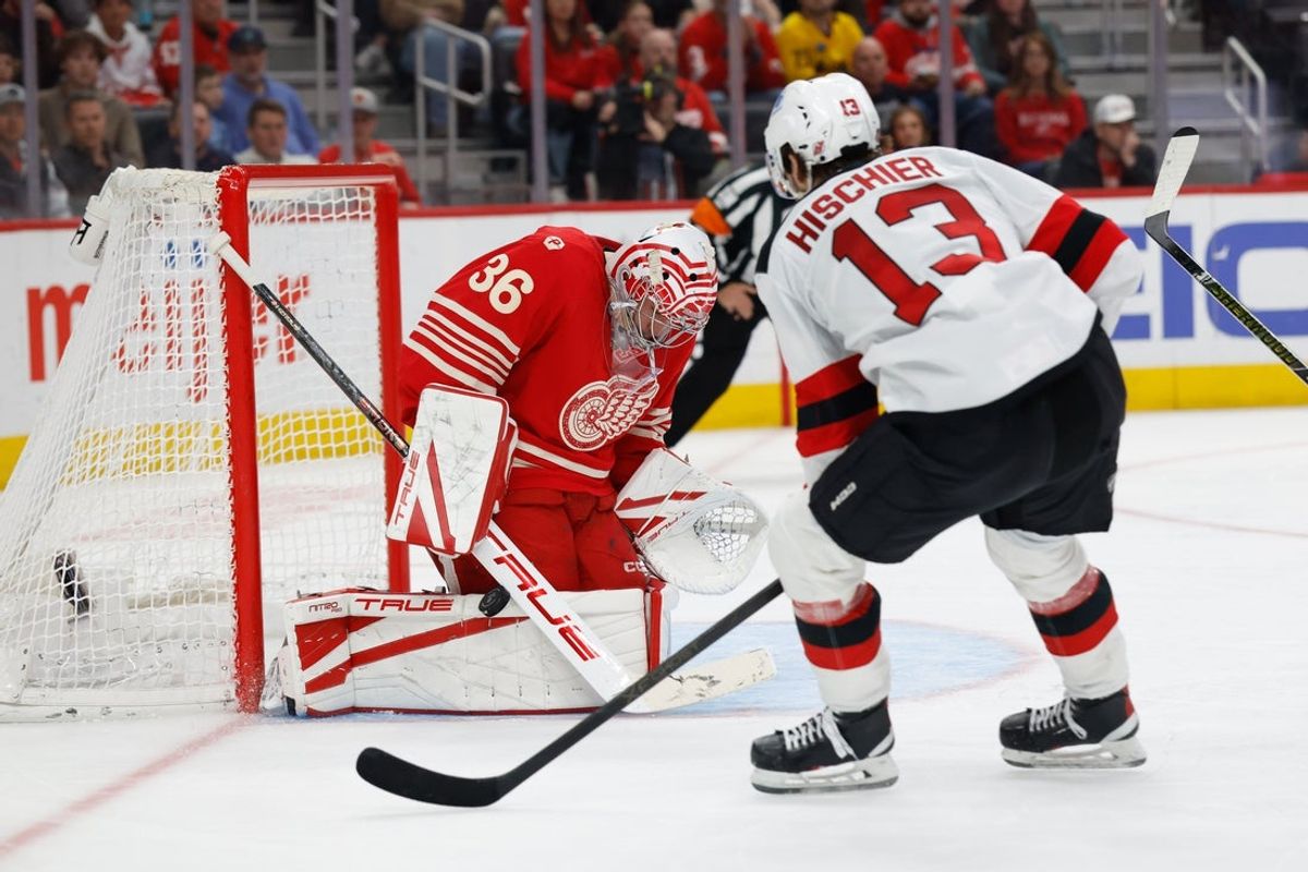Apr 11, 2026; Detroit, Michigan, USA;  Detroit Red Wings goaltender John Gibson (36) makes a save on New Jersey Devils center Nico Hischier (13) in the third period at Little Caesars Arena. Mandatory Credit: Rick Osentoski-Imagn Images