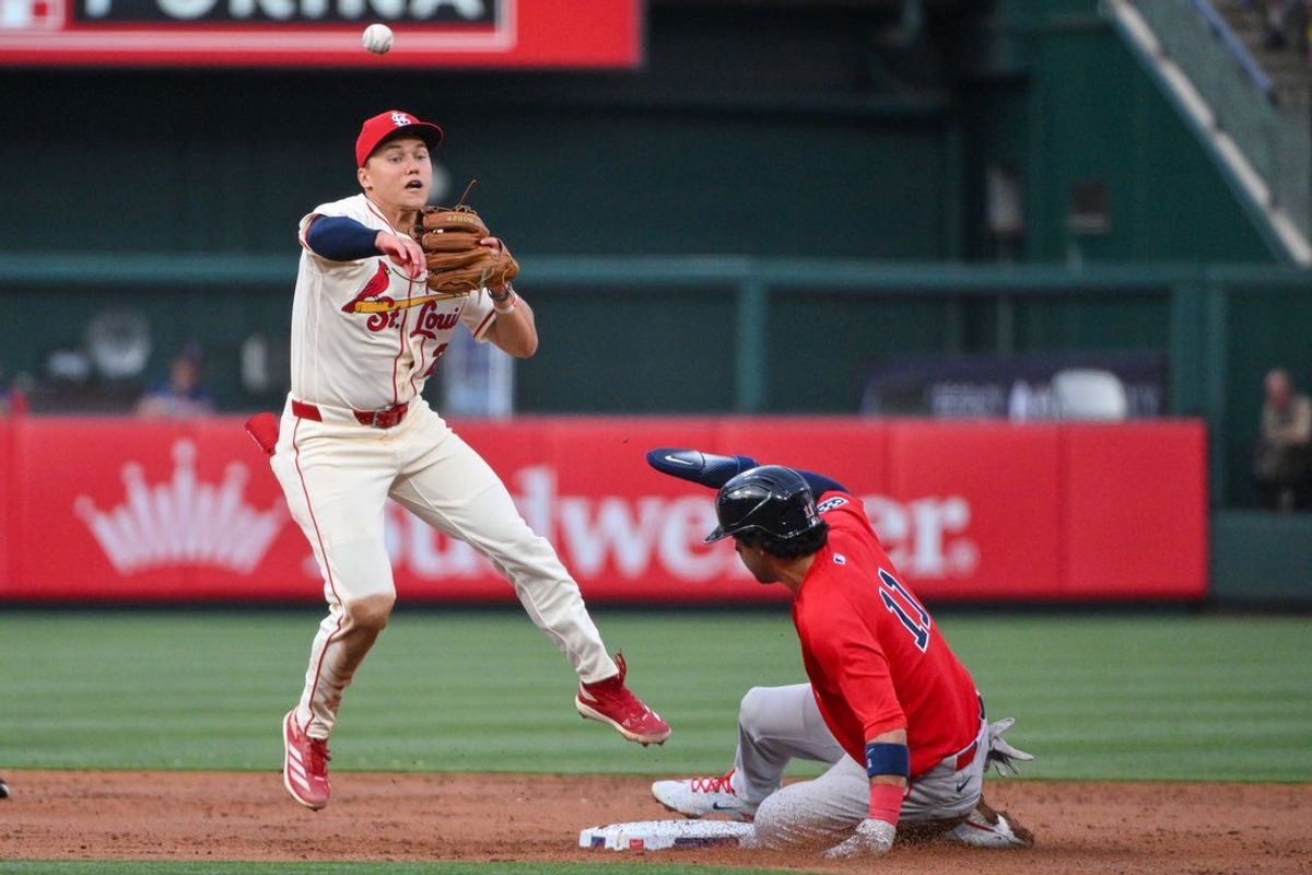 Apr 11, 2026; St. Louis, Missouri, USA; St. Louis Cardinals second baseman JJ Wetherholt (26) leaps and throws to first after forcing out Boston Red Sox second baseman Marcelo Mayer (11) during the third inning at Busch Stadium. Mandatory Credit: Jeff Curry-Imagn Images