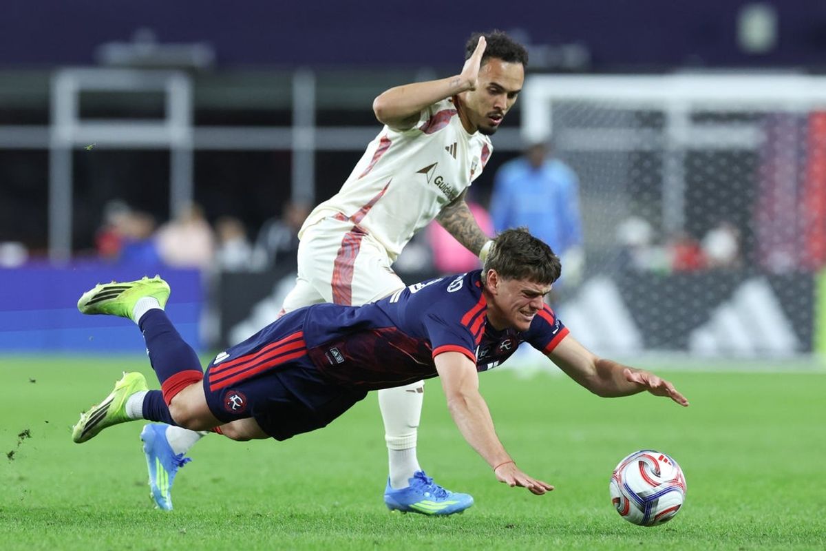 Apr 11, 2026; Foxborough, Massachusetts, USA; D.C. United forward Joao Peglow (7) fouls New England Revolution defender Ilay Feingold (12) during the first half at Gillette Stadium. Mandatory Credit: Paul Rutherford-Imagn Images