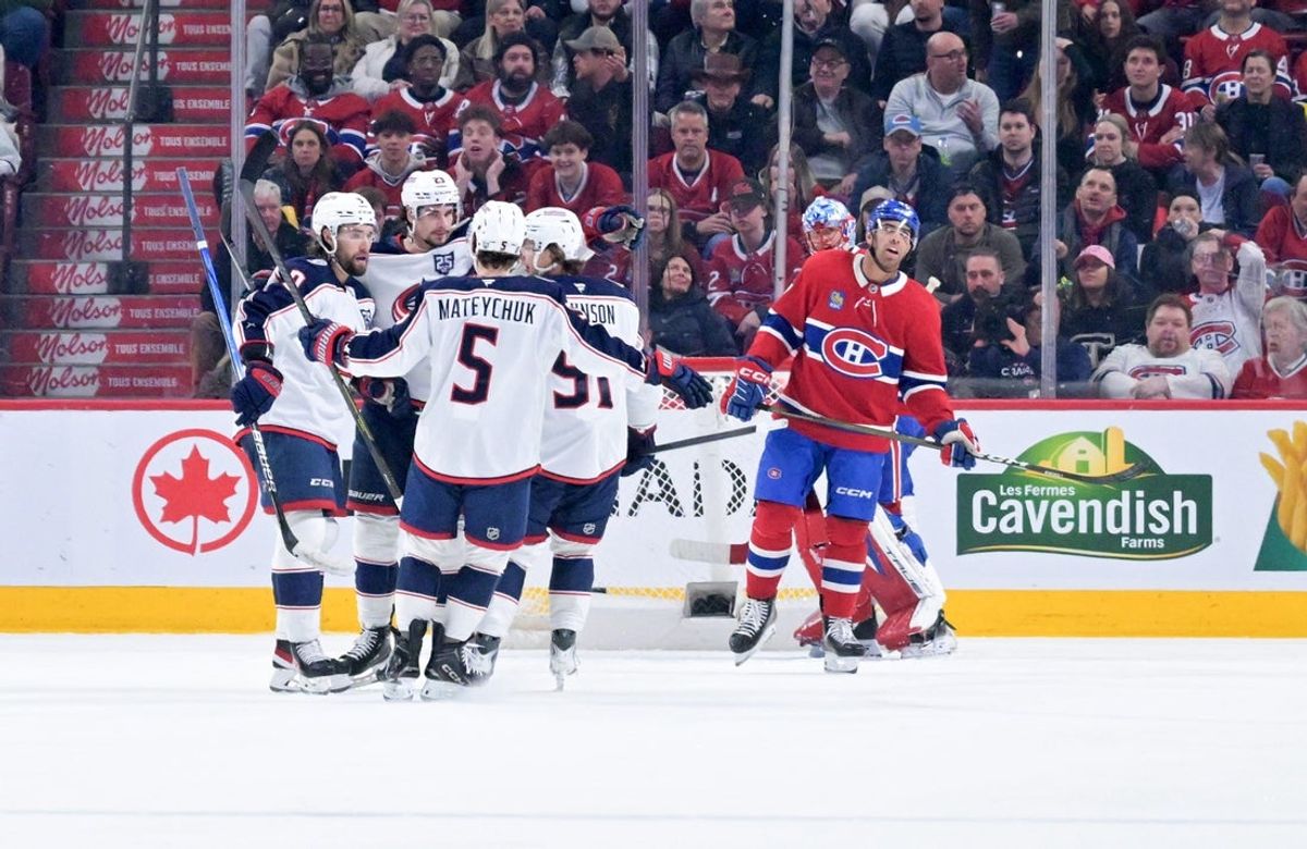 Apr 11, 2026; Montreal, Quebec, CAN; Columbus Blue Jackets forward Sean Monahan (23) celebrates with teammates after scoring a goal against Montreal Canadiens goalie Jakub Dobes (75) during the second period at the Bell Centre. Mandatory Credit: Eric Bolte-Imagn Images