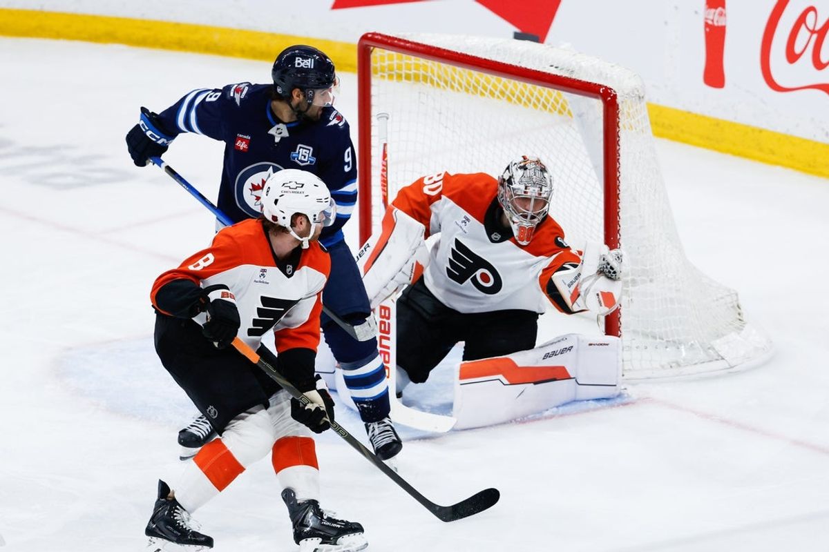 Apr 11, 2026; Winnipeg, Manitoba, CAN;  Philadelphia Flyers goalie Dan Vladar (80)  makes a save as Winnipeg Jets forward Alex Iafallo (9) looks for a rebound during the second period at Canada Life Centre. Mandatory Credit: Terrence Lee-Imagn Images