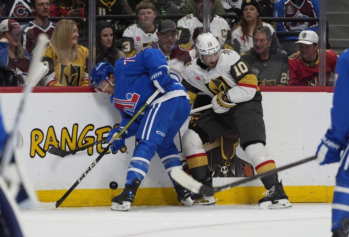 Apr 11, 2026; Denver, Colorado, USA; Colorado Avalanche defenseman Sam Malinski (70) and Vegas Golden Knights center Colton Sissons (10) battle for the puck in the first period at Ball Arena. Mandatory Credit: Ron Chenoy-Imagn Images