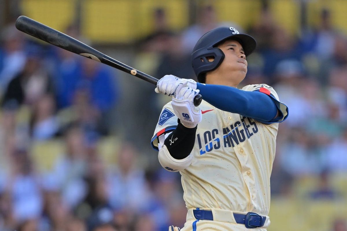 Apr 11, 2026; Los Angeles, California, USA; Los Angeles Dodgers two-way player Shohei Ohtani (17) hits a solo home run against the Texas Rangers during the first inning at Dodger Stadium. Mandatory Credit: Jayne Kamin-Oncea-Imagn Images