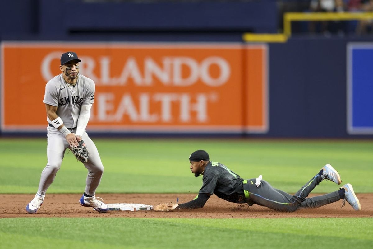 Apr 11, 2026; St. Petersburg, Florida, USA; Tampa Bay Rays left fielder Chandler Simpson (14) steals second from New York Yankees shortstop Jose Caballero (72) in the tenth inning at Tropicana Field. Mandatory Credit: Nathan Ray Seebeck-Imagn Images