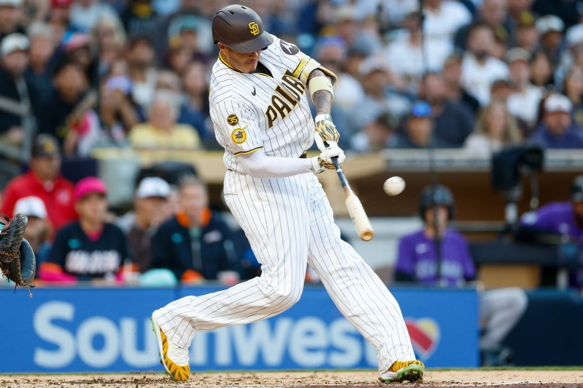 Apr 11, 2026; San Diego, California, USA; San Diego Padres third baseman Manny Machado (13) hits a two-run home run during the third inning against the Colorado Rockies at Petco Park. Mandatory Credit: David Frerker-Imagn Images