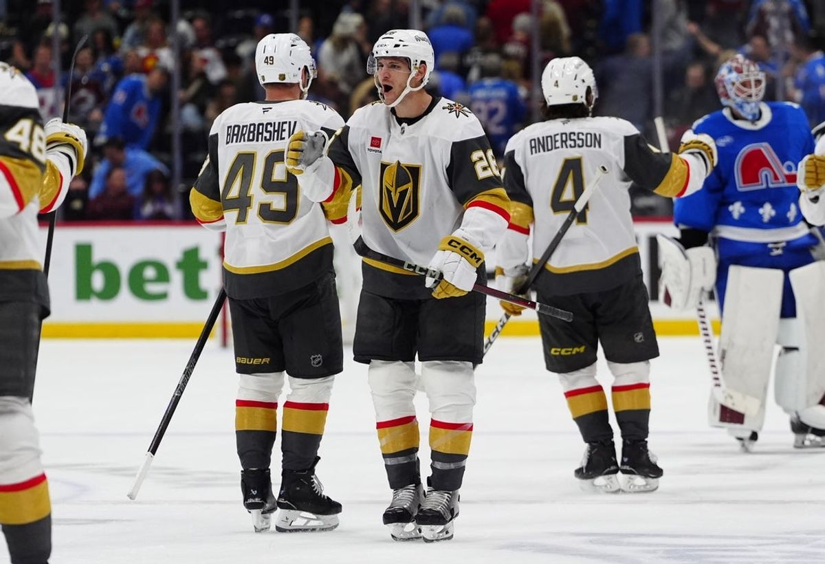 Apr 11, 2026; Denver, Colorado, USA; Vegas Golden Knights center Nic Dowd (26) and left wing Ivan Barbashev (49) celebrate an overtime win against the Colorado Avalanche at Ball Arena. Mandatory Credit: Ron Chenoy-Imagn Images