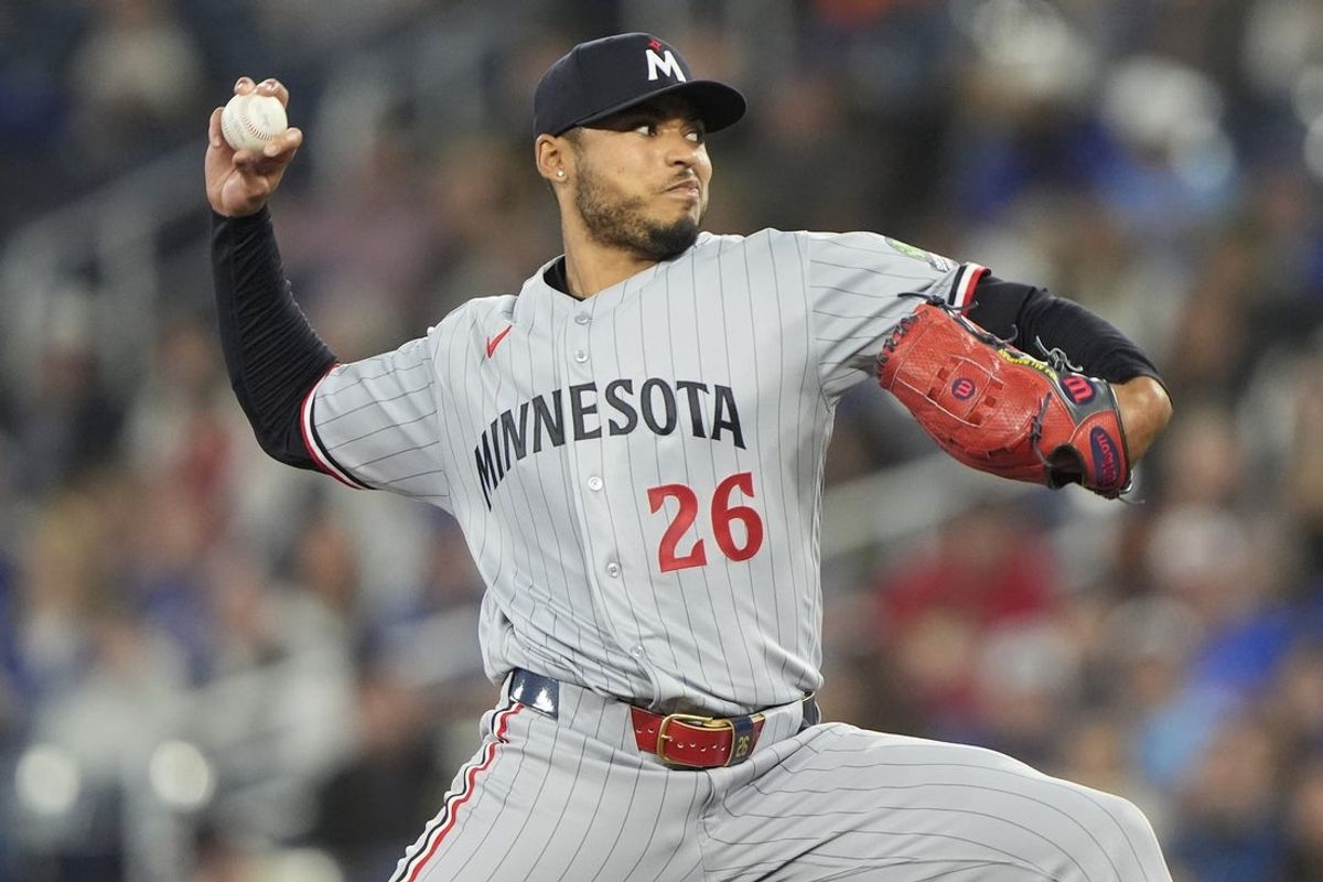 Apr 12, 2026; Toronto, Ontario, CAN; Minnesota Twins starting pitcher Taj Bradley (26) pitches to the Toronto Blue Jaysduring the first inning at Rogers Centre. Mandatory Credit: John E. Sokolowski-Imagn Images