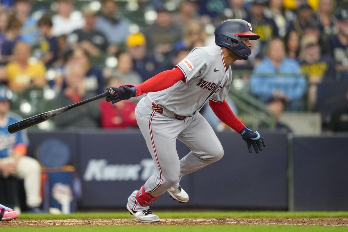 Apr 12, 2026; Milwaukee, Wisconsin, USA;  Washington Nationals pinch hitter Jose Tena (8) hits an RBI single during the seventh inning against the Milwaukee Brewers at American Family Field. Mandatory Credit: Jeff Hanisch-Imagn Images