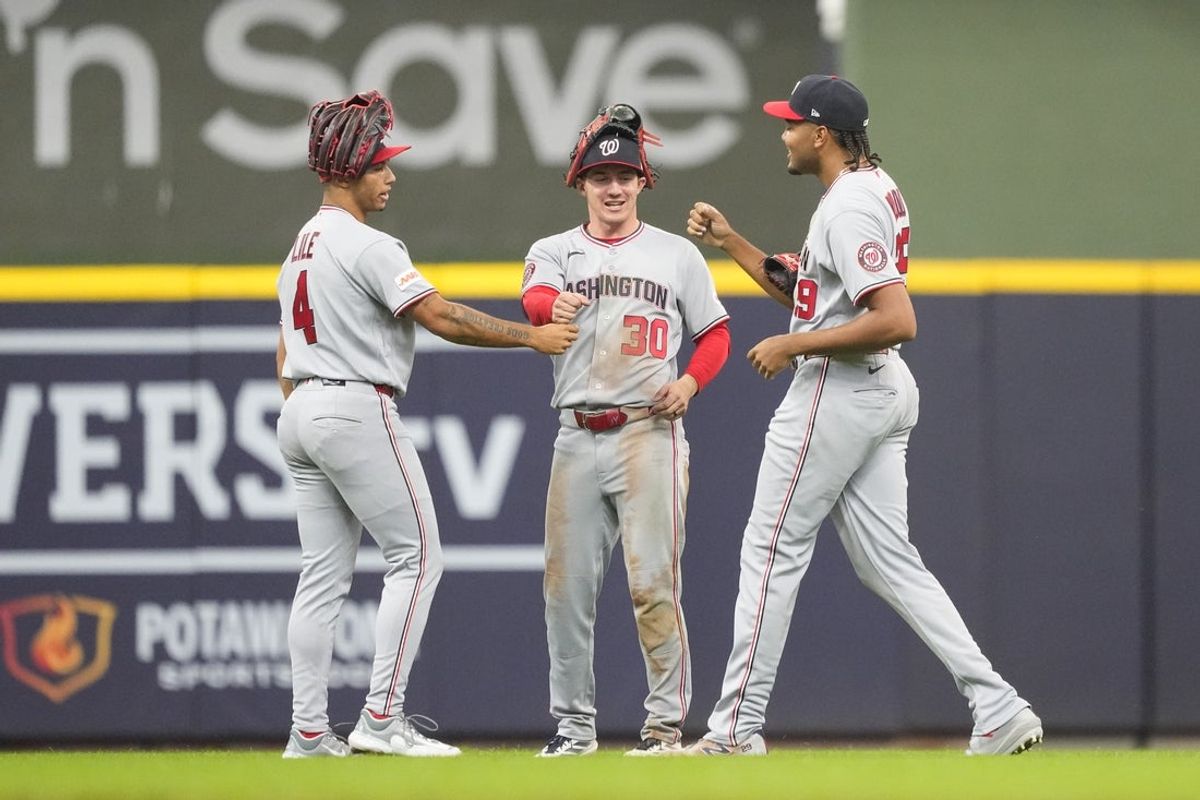 Apr 12, 2026; Milwaukee, Wisconsin, USA;  Washington Nationals outfielders Daylen Lile (4), Jacob Young (30) and James Wood (29) celebrate following the game against the Milwaukee Brewers at American Family Field. Mandatory Credit: Jeff Hanisch-Imagn Images